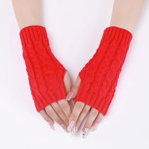 Close-up of red cable knit arm warmers with fingerless design and ribbed texture cuffs