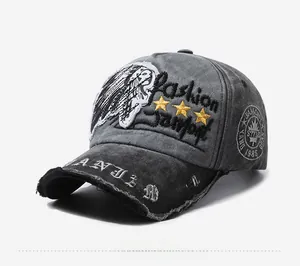 Detail of vintage gray baseball cap featuring embroidery and distressed brim texture