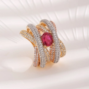 Cross-layered gold and silver ring with sparkling clear stones and a center red oval zircon