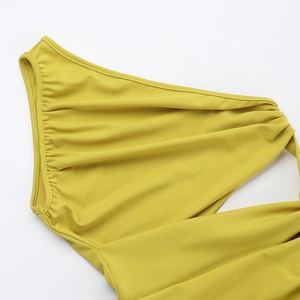 Detail of mustard yellow one-shoulder dress with elegant ruched fabric and pleats