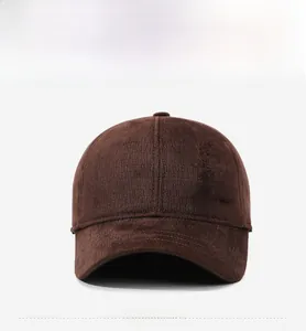 Detail of dark brown corduroy baseball cap featuring a metal 'Fashion' brand plate