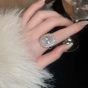Close-up of a luxury oval zircon ring with double layer settings worn on a finger