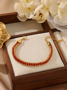 Detailed shot of 18K gold plated bracelet with red zirconia and adjustable lobster clasp