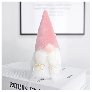 Pink velvet Christmas gnome decoration with long white beard on decorative books