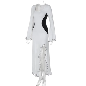 Détail d'une robe longue moulante avec ourlet ondulé noir et empiècements contrastés
