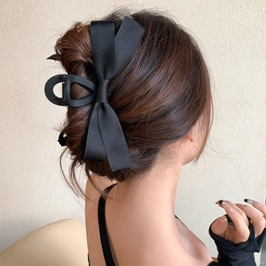 Large black satin bow hair claw clip for elegant French-style updo hairstyles