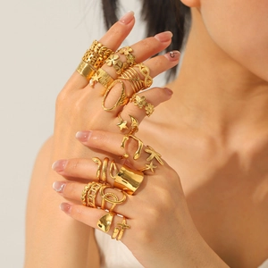 Golden stainless steel ring set with flower, star and moon shapes worn by a model