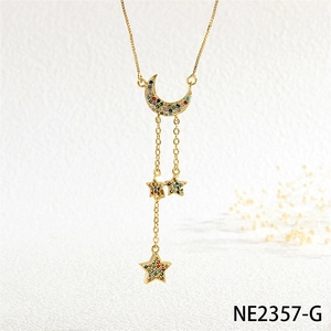 Macro detail of gold moon and star pendant with colorful zircon stones on box chain