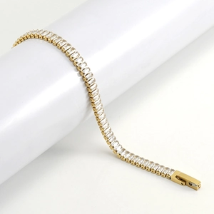 Detailed close-up of a gold square zircon tennis bracelet with a secure fold-over clasp