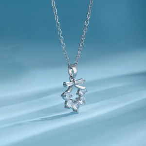 Macro detail of a silver bowknot flower necklace pendant with sparkling zircon stones