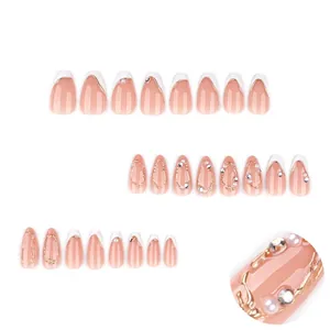 3D almond press-on nails with French white tips, nude pink base, pearls and rhinestones