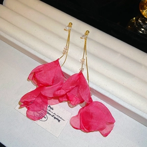 Detail of elegant gold tassel earrings with pink fabric petals and clear faceted beads