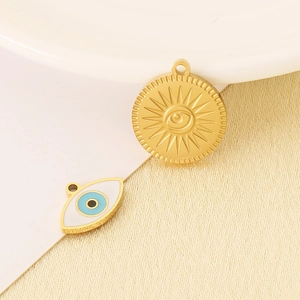 Detail of 18K gold-plated Evil Eye and sunburst pendants for DIY jewelry making
