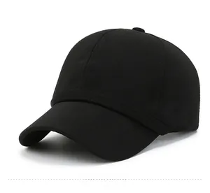 Detailed view of black baseball cap texture with small metal shield logo on the side