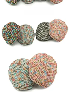 Detailed view of colorful woven textures and patterns on retro British flat caps