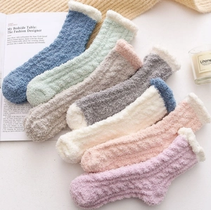 Detailed close-up of colorful thick coral fleece socks with white plush cuffs