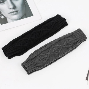 Detail of diamond knit cable pattern on warm winter fingerless arm warmers in gray
