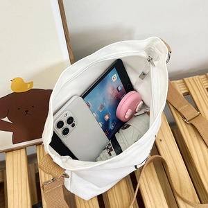 Internal view of a spacious canvas tote showing storage for a tablet and umbrella