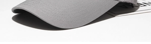 Detail of grey cotton baseball cap showing reinforced six-row stitching on the brim