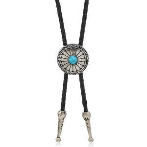 Close-up of black braided leather bolo tie with turquoise stone and silver metal pendant