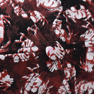 Macro detail of crab pattern fabric and top button on a textured baseball cap