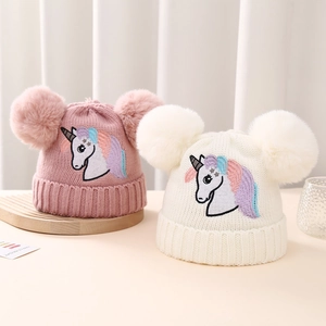 Knitted winter beanies for girls with fluffy double pom poms and unicorn embroidery