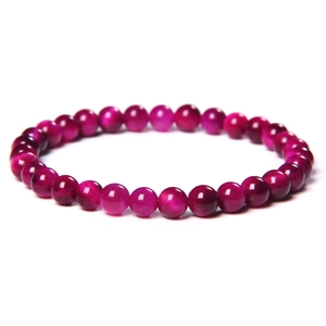 Macro shot of 8mm rose red cat eye beads bracelet with vibrant optical reflection