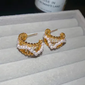 Elegant 18k gold plated C-shaped hollow earrings with small white pearls on velvet
