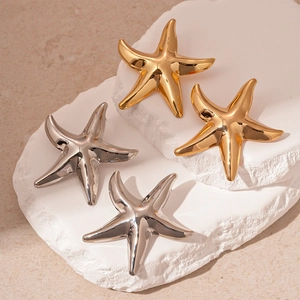 Minimalist starfish stud earrings in polished gold and silver metal finishes