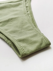 Macro detail of olive green ribbed cotton panties showing neat stitching and soft fabric
