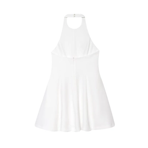 Detail of white halter neck sleeveless dress with wavy hemline on plain background