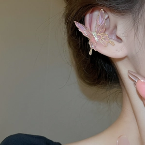 Detail of pink gradient butterfly ear cuff with gold metallic edges on model