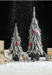 Close-up of mini PE snow-sprayed Christmas trees with red berries and pine cones