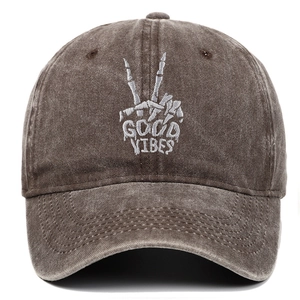 Detail of Good Vibes skull hand embroidery on washed brown cotton baseball cap