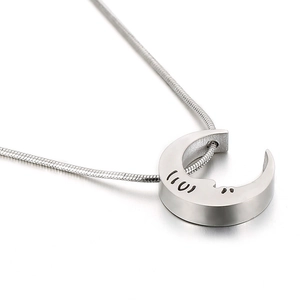 Minimalist silver moon pendant necklace with smiling face engraving on a snake chain