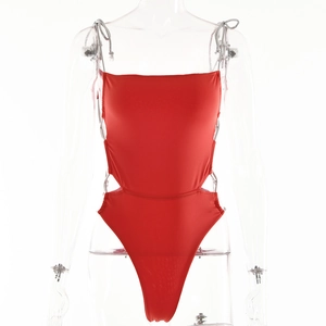 Detail view of red one-piece swimsuit featuring side cut-outs and slim shoulder straps
