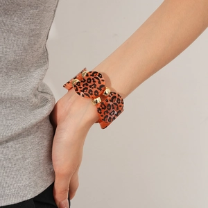 Detail of leopard print acrylic discs and gold metal links on a stylish bracelet