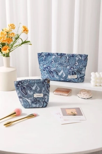 Close-up of blue paisley fabric cosmetics bags with vintage jacquard texture