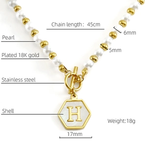 Detail of 18K gold plated toggle clasp pearl necklace with hexagonal H shell pendant