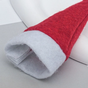 Close-up of red and white felt mini Christmas hats with soft texture for holiday decor