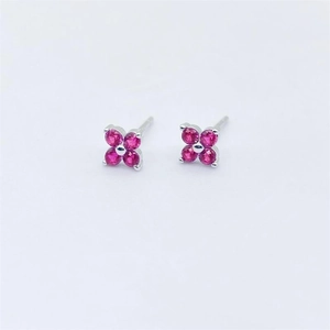 Detail of S925 sterling silver stud earrings with red four-petal flower gemstones