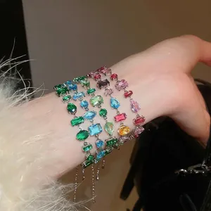 Elegant silver bracelet with irregular colorful zircon stones in drop and square shapes