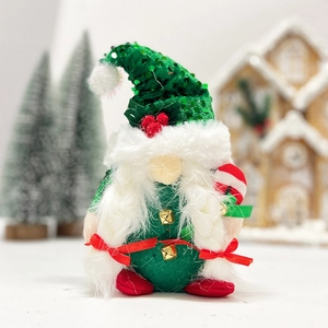Close-up of a Christmas gnome doll with green sequin hat and white beard in a festive scene