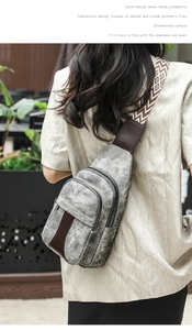Detail of grey crossbody bag showing vintage texture and geometric pattern strap