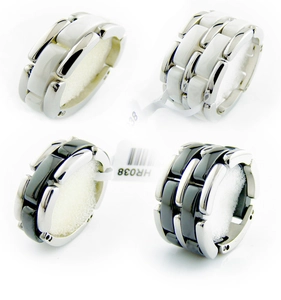 Detailed macro view of black and white ceramic link rings with polished metal connectors