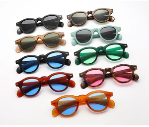 Detailed view of retro round acetate sunglasses with metal arrow hinges in various colors