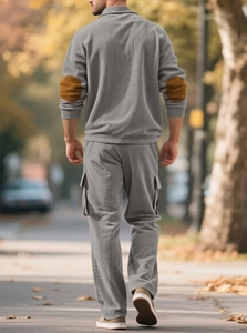 Rear view of men's casual grey corduroy tracksuit with brown elbow patches in street setting