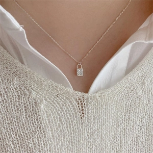 Minimalist 925 sterling silver necklace with rectangular zircon pendant worn by a model