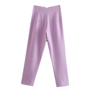 Detail view of light purple high-waisted tailored trousers with smooth fabric texture