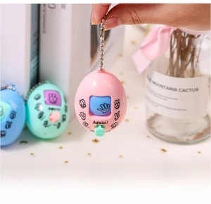 Close-up of pink rock-paper-scissors game keychain with pastel blue and green variants